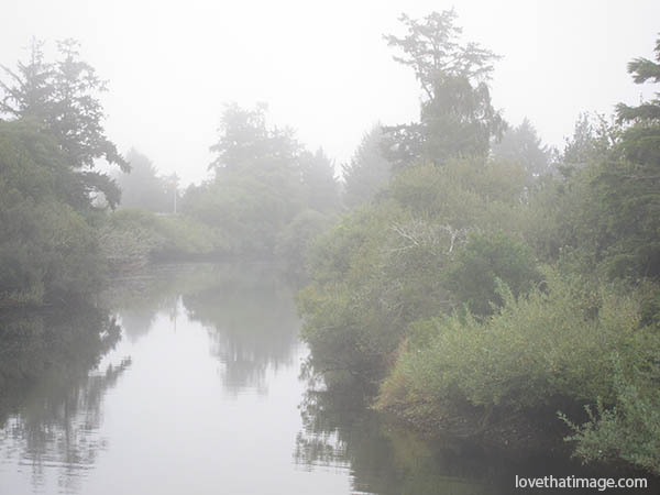 Foggy weather and the creek at high tide in Seaside, Oregon